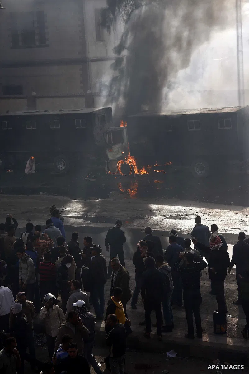 Police vehicles are set on fire by anti-government demonstrators in Cairo, capital of Egypt, on Friday, Jan. 28, 2011. Photo by Karam Nasser