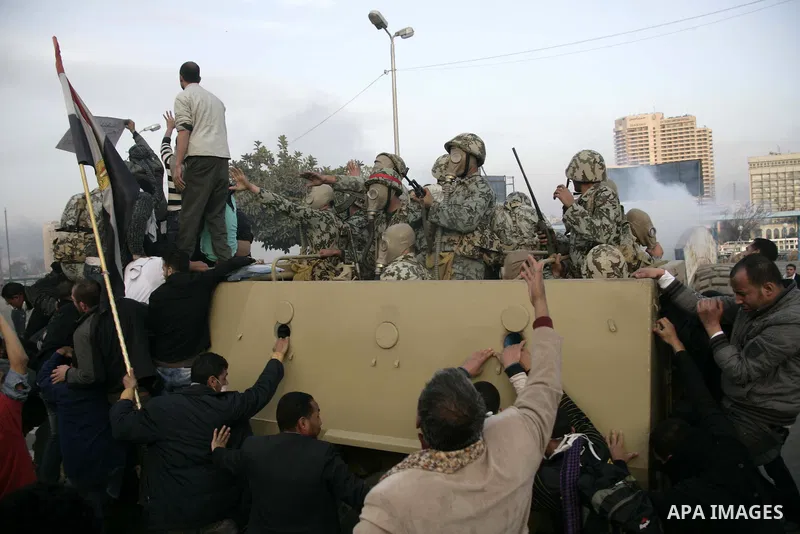 Egyptian Army soldiers riding in an armored personnel carrier is surrounded by anti-government protesters near Tahrir square in Cairo, Egypt, Friday, Jan. 28, 2011. Photo by Karam Nasser
