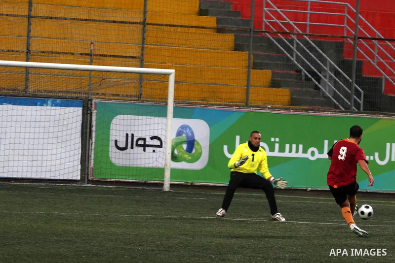 Palestinians play a football match between Tulkarem Cultural club and Balata Camp club in the occupied West Bank on Feb. 1,2011. Photo by Issam Rimawi