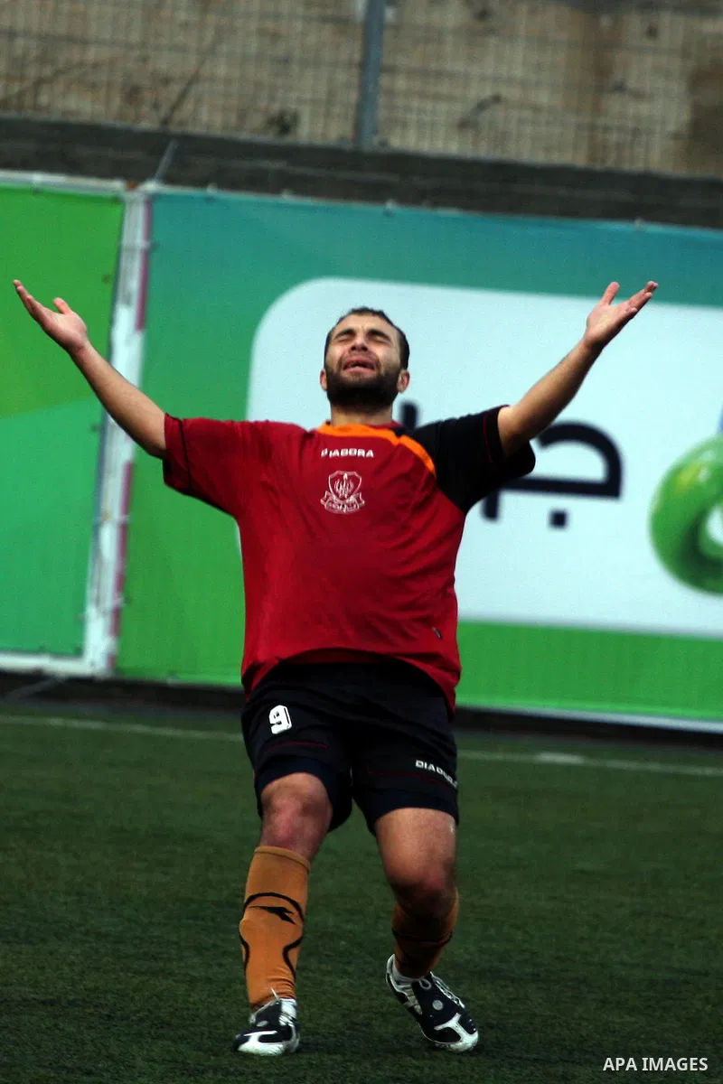 Palestinians play a football match between Tulkarem Cultural club and Balata Camp club in the occupied West Bank on Feb. 1,2011. Photo by Issam Rimawi
