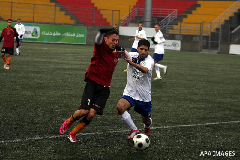 Palestinians play a football match between Tulkarem Cultural club and Balata Camp club in the occupied West Bank on Feb. 1,2011. Photo by Issam Rimawi