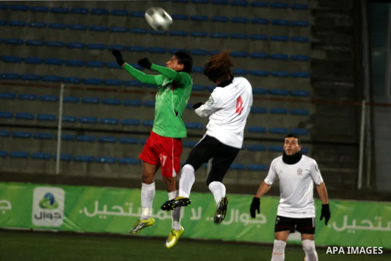 Palestinians play a football match between Mukaber Mountain club and Amari camp club in the occupied West Bank on Feb. 1,2011. Photo by Issam Rimawi