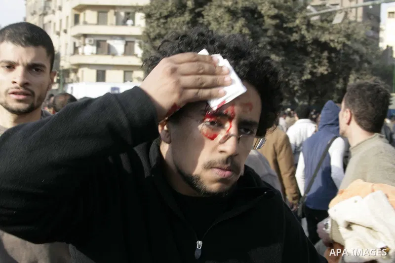 An injured man are seen as pro Mubarak and anti Mubarak protesters clash in Tahrir square, in Cairo, Egypt, 02 February 2011. Media reports state on 02 February 2011 that clashes broke out in the main square of the Egypt...