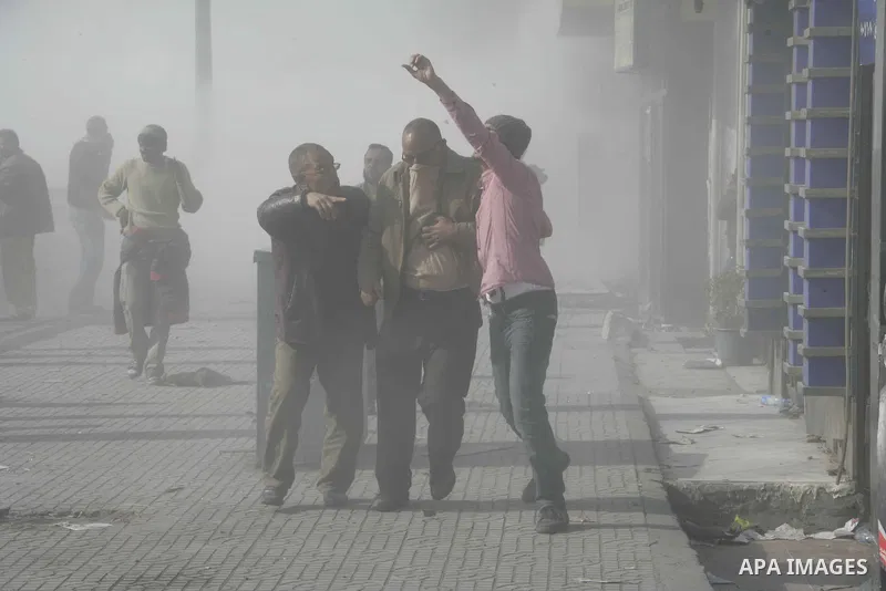 A man is helped away as anti-government protesters clash violently with supporters of President Hosni Mubarak in Tahrir Square in Cairo on 02 February 2011 as Egypt's political upheaval took a dangerous new turn. Photo b...