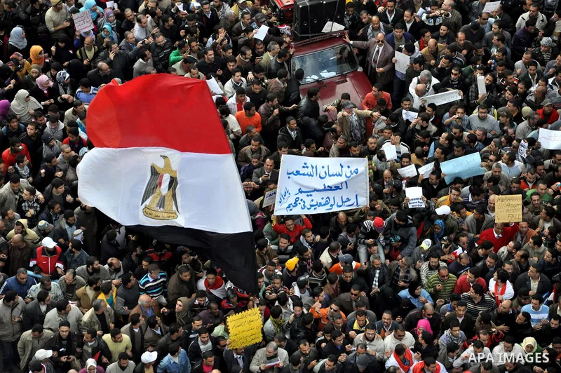 Anti-government demonstrators march in Alexandria, Egypt, Tuesday, Feb.1, 2011. Egyptian President Hosni Mubarak defied a quarter-million protesters demanding he step down immediately, announcing he would serve out the l...