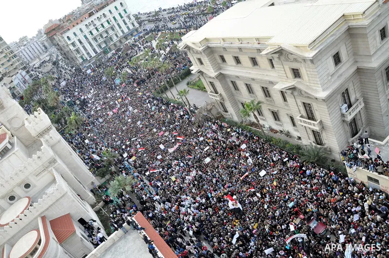 Anti-government demonstrators march in Alexandria, Egypt, Tuesday, Feb.1, 2011. Egyptian President Hosni Mubarak defied a quarter-million protesters demanding he step down immediately, announcing he would serve out the l...