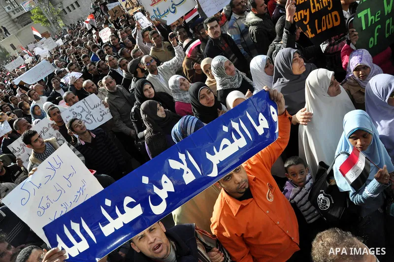 Anti-government demonstrators march in Alexandria, Egypt, Tuesday, Feb.1, 2011. Egyptian President Hosni Mubarak defied a quarter-million protesters demanding he step down immediately, announcing he would serve out the l...