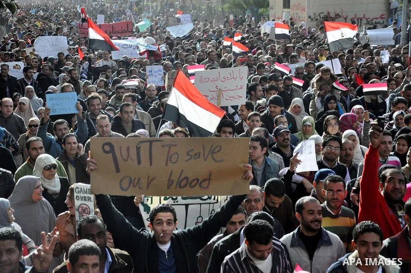 Anti-government demonstrators march in Alexandria, Egypt, Tuesday, Feb.1, 2011. Egyptian President Hosni Mubarak defied a quarter-million protesters demanding he step down immediately, announcing he would serve out the l...