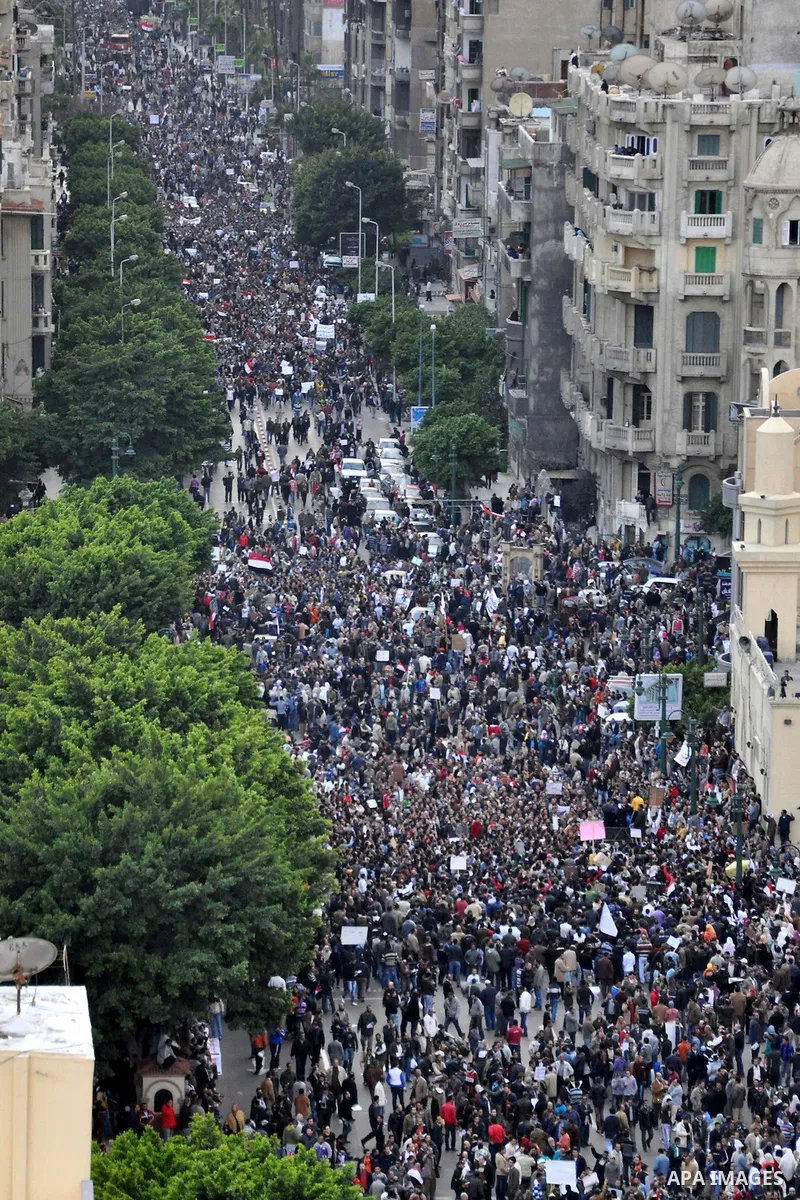 Anti-government demonstrators march in Alexandria, Egypt, Tuesday, Feb.1, 2011. Egyptian President Hosni Mubarak defied a quarter-million protesters demanding he step down immediately, announcing he would serve out the l...