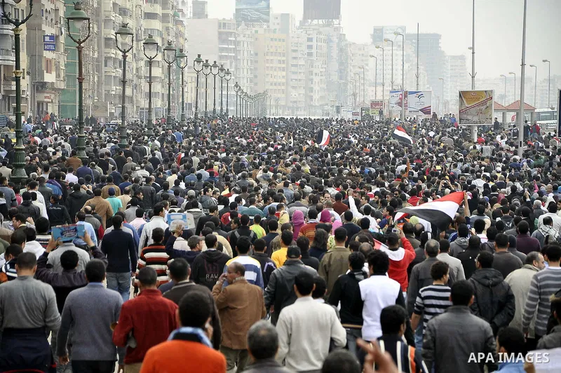 Anti-government demonstrators march in Alexandria, Egypt, Jan. 28, 2011. Egyptian President Hosni Mubarak defied a quarter-million protesters demanding he step down immediately, announcing he would serve out the last mon...