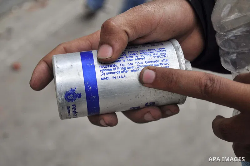 An Egyptian protestor holds a tear gas made in U.S.A " as shown ", during a march in Alexandria, Egypt, Jan. 28, 2011. Egyptian President Hosni Mubarak defied a quarter-million protesters demanding he step down immediate...