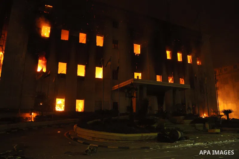 Fire rages outside the building during a anti-government protesters demonstrate against president Hosni Mubarak regime in Alexandria, Egypt, Jan. 28, 2011. Egyptian President Hosni Mubarak defied a quarter-million protes...