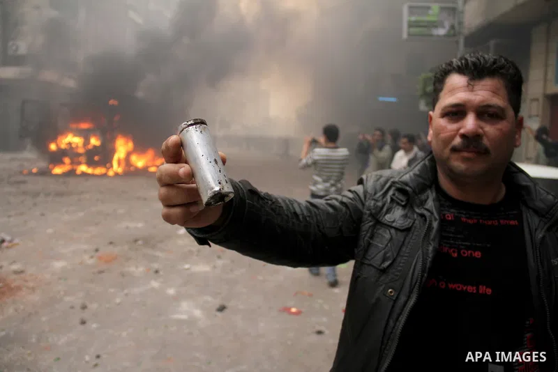 An Egyptian protestor holds a tear gas , during a march in Alexandria, Egypt, Jan. 28, 2011. Egyptian President Hosni Mubarak defied a quarter-million protesters demanding he step down immediately, announcing he would se...