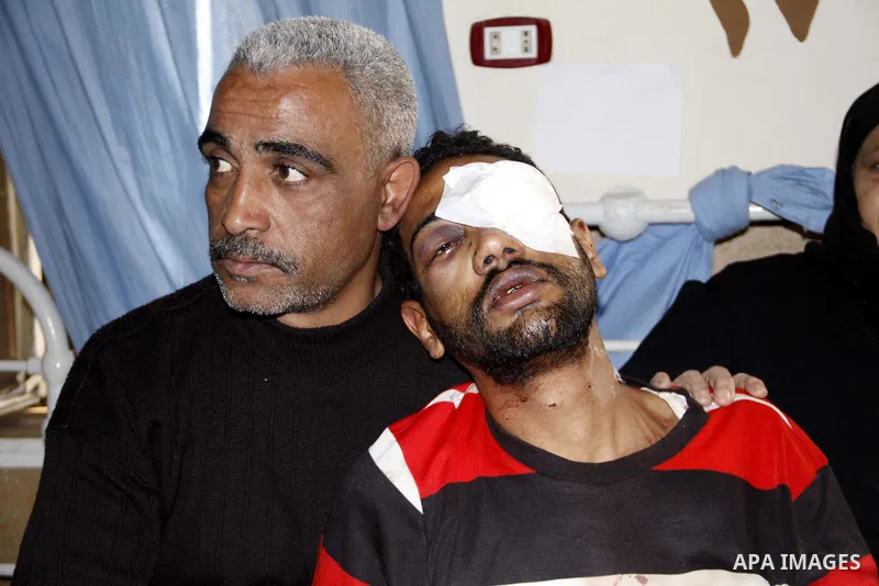 A wounded protester is being treated after being injured during clashes in Cairo's main square, Egypt, Thursday, Feb. 3, 2011. Egyptian army tanks and soldiers moved to end violence between anti-government protesters and...