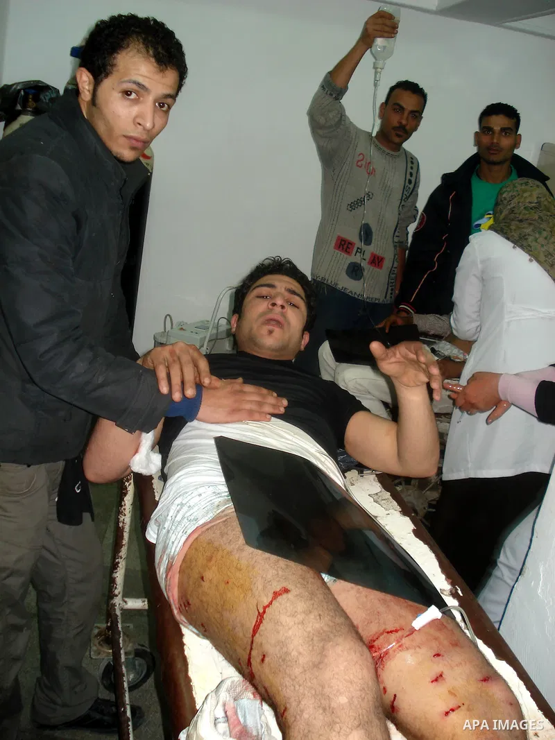 A wounded protester is being treated after being injured during clashes in Cairo's main square, Egypt, Thursday, Feb. 3, 2011. Egyptian army tanks and soldiers moved to end violence between anti-government protesters and...