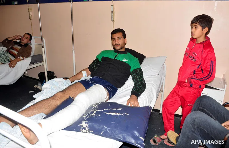 A wounded protester is being treated after being injured during clashes in Cairo's main square, Egypt, Thursday, Feb. 3, 2011. Egyptian army tanks and soldiers moved to end violence between anti-government protesters and...