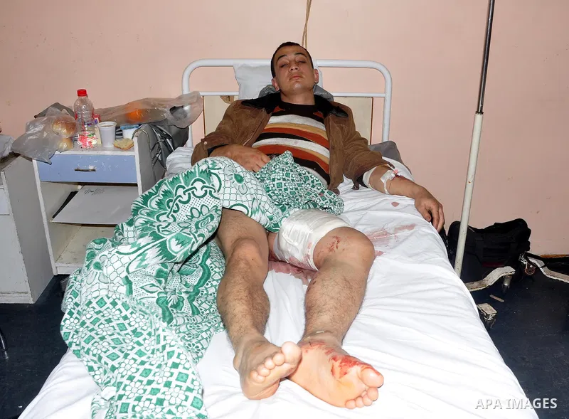 A wounded protester is being treated after being injured during clashes in Cairo's main square, Egypt, Thursday, Feb. 3, 2011. Egyptian army tanks and soldiers moved to end violence between anti-government protesters and...