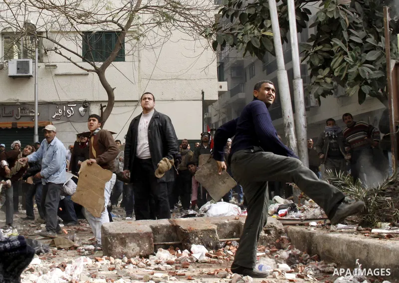 Egyptian pro government protesters throw stones at anti government protesters in downtown Cairo, Egypt, Thursday, Feb. 3, 2011. New clashes are heating up again and shots are being fired in the air around Cairo's central...