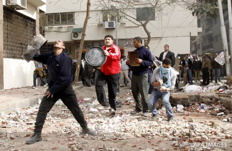 Egyptian pro government protesters throw stones at anti government protesters in downtown Cairo, Egypt, Thursday, Feb. 3, 2011. New clashes are heating up again and shots are being fired in the air around Cairo's central...