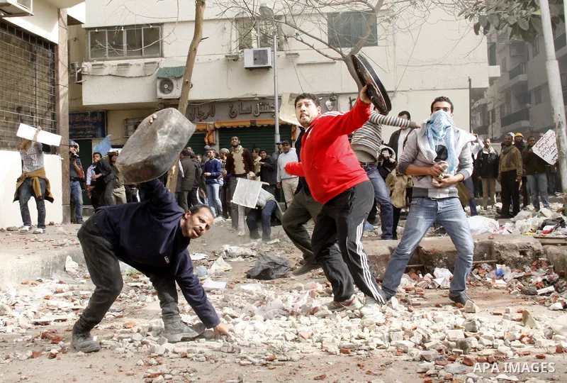 Egyptian pro government protesters throw stones at anti government protesters in downtown Cairo, Egypt, Thursday, Feb. 3, 2011. New clashes are heating up again and shots are being fired in the air around Cairo's central...