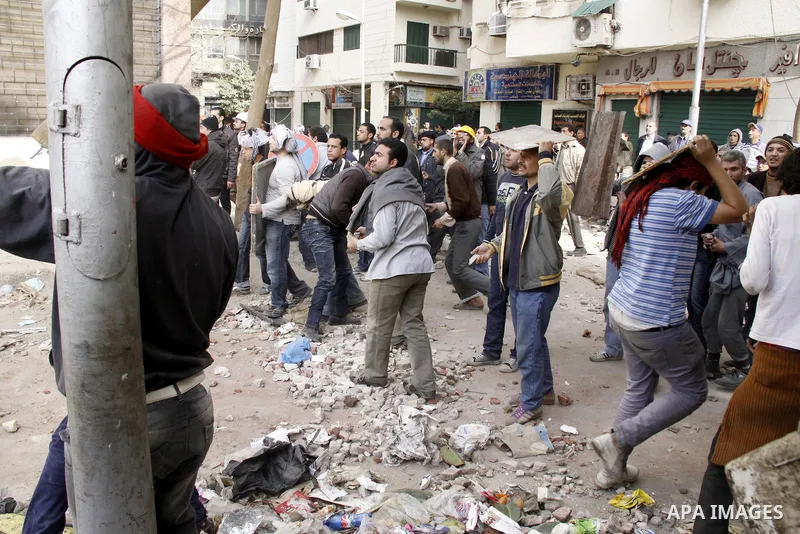 Egyptian pro government protesters throw stones at anti government protesters in downtown Cairo, Egypt, Thursday, Feb. 3, 2011. New clashes are heating up again and shots are being fired in the air around Cairo's central...