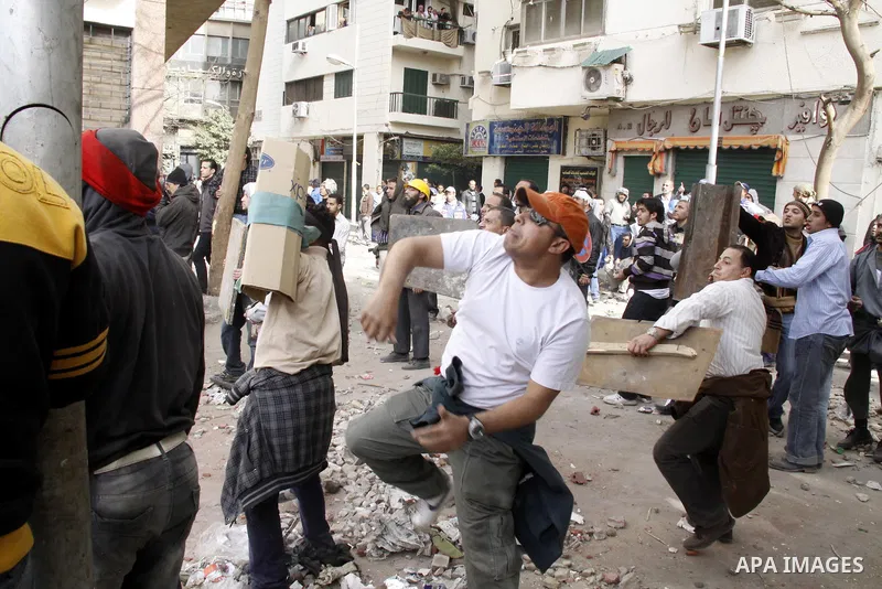 Egyptian pro government protesters throw stones at anti government protesters in downtown Cairo, Egypt, Thursday, Feb. 3, 2011. New clashes are heating up again and shots are being fired in the air around Cairo's central...