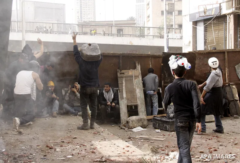 Egyptian pro government protesters throw stones at anti government protesters in downtown Cairo, Egypt, Thursday, Feb. 3, 2011. New clashes are heating up again and shots are being fired in the air around Cairo's central...