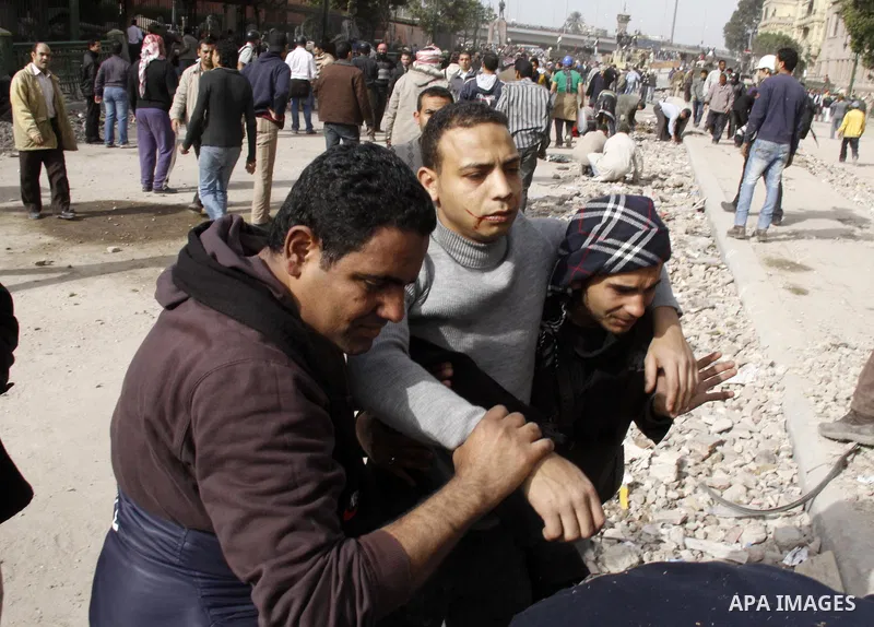 A wounded protester is being treated after being injured during clashes in Cairo's main square, Egypt, Thursday, Feb. 3, 2011. Egyptian army tanks and soldiers moved to end violence between anti-government protesters and...