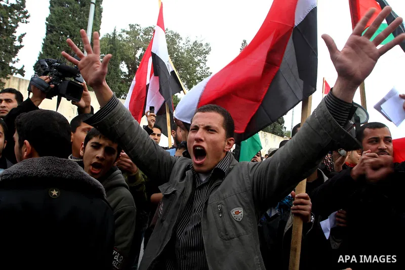 Palestinian protesters wave Egyptian flags and shout slogans during a demonstration outside the offices of the Egyptian diplomatic mission in Gaza City on February 3, 2011 in support of the anti-government protests in Eg...