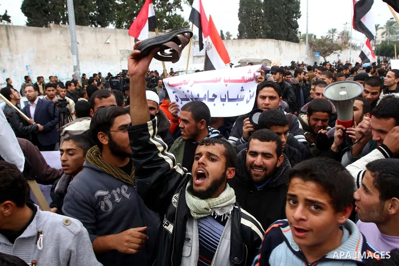 Palestinian protesters wave Egyptian flags and shout slogans during a demonstration outside the offices of the Egyptian diplomatic mission in Gaza City on February 3, 2011 in support of the anti-government protests in Eg...