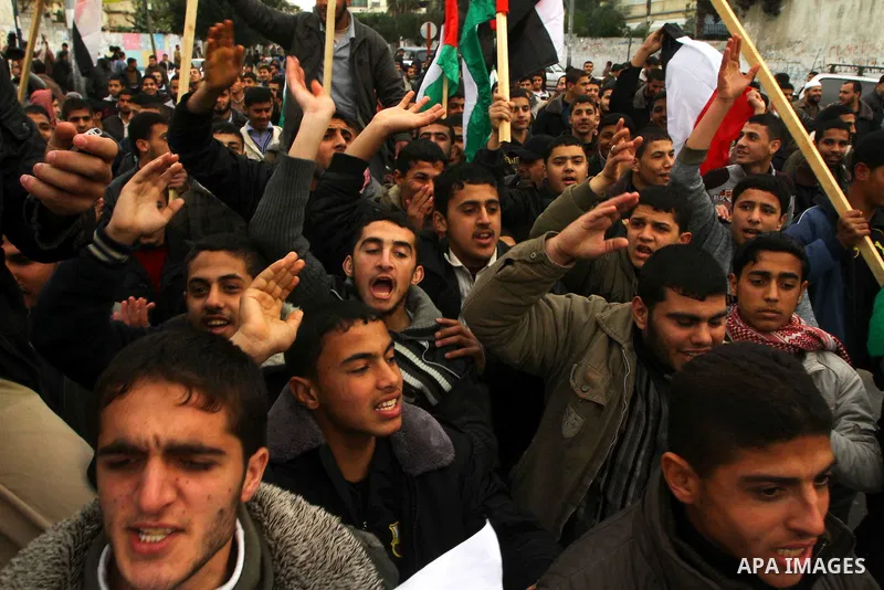 Palestinian protesters wave Egyptian flags and shout slogans during a demonstration outside the offices of the Egyptian diplomatic mission in Gaza City on February 3, 2011 in support of the anti-government protests in Eg...