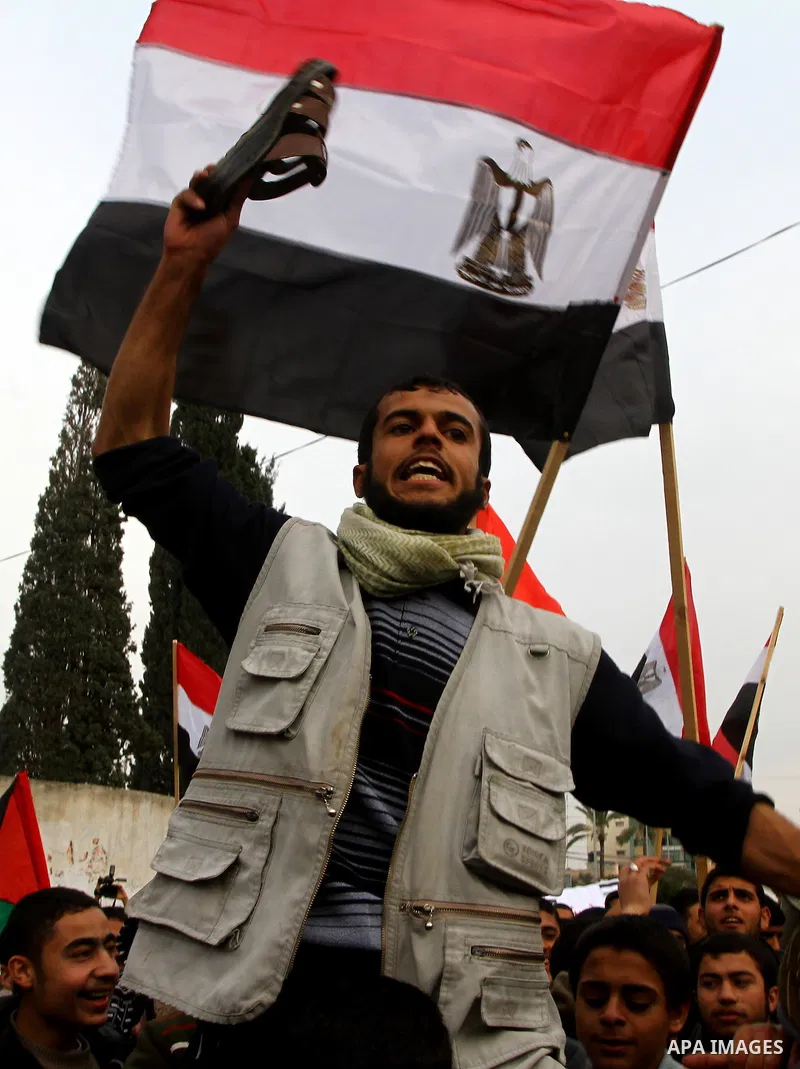 Palestinian protesters wave Egyptian flags and shout slogans during a demonstration outside the offices of the Egyptian diplomatic mission in Gaza City on February 3, 2011 in support of the anti-government protests in Eg...