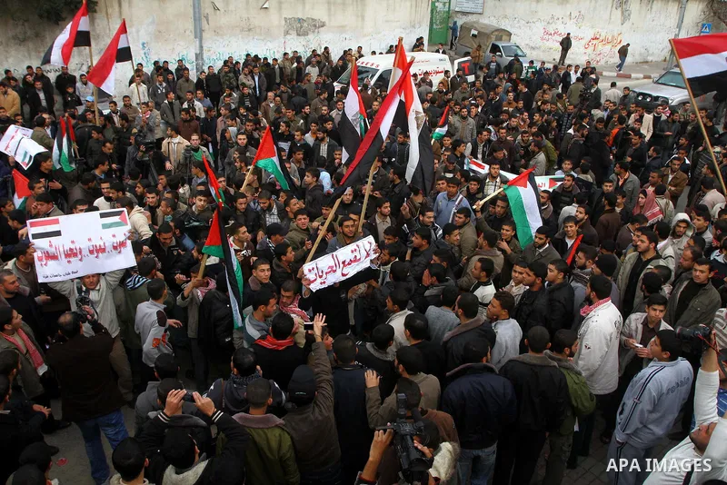 Palestinian protesters wave Egyptian flags and shout slogans during a demonstration outside the offices of the Egyptian diplomatic mission in Gaza City on February 3, 2011 in support of the anti-government protests in Eg...