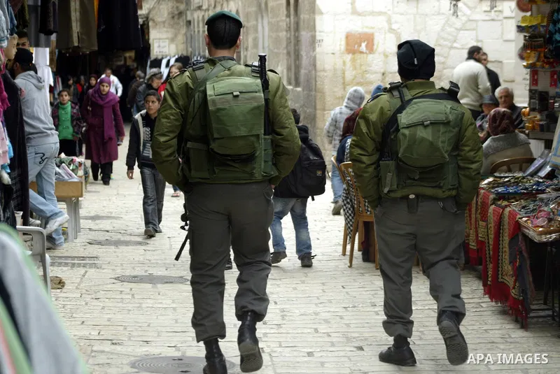 Israeli police officers walk in the market of the old city of Jerusalem on Feb. 3,2011. Photo by Mahfouz Abu Turk