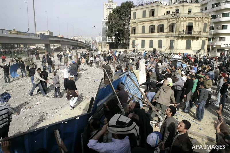 Egyptian protesters are seen in and around Tahrir square, as supporters and opponents of President Hosni Mubarak clash in some parts of the square, Cairo, capital of Egypt, Feb. 3, 2011. Egyptian army appeared to be tryi...