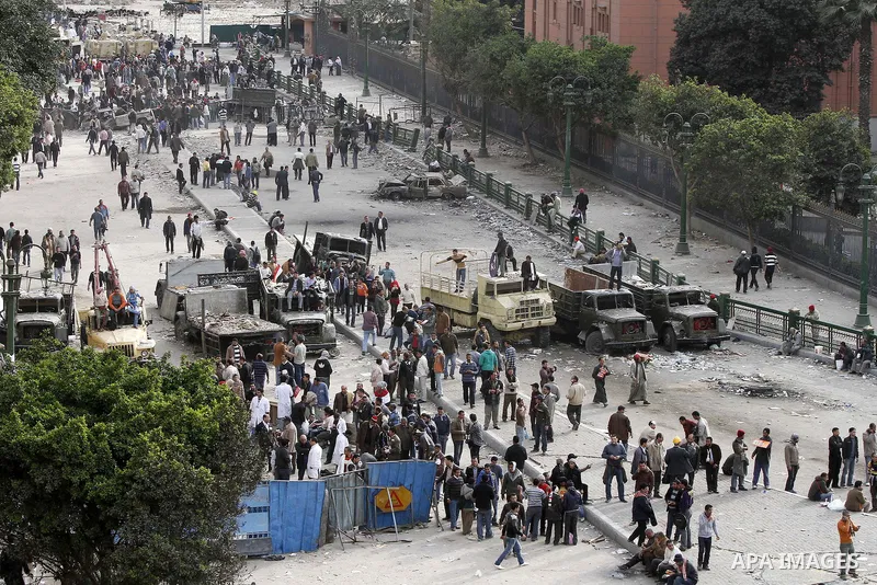 Egyptian protesters are seen in and around Tahrir square, as supporters and opponents of President Hosni Mubarak clash in some parts of the square, Cairo, capital of Egypt, Feb. 3, 2011. Egyptian army appeared to be tryi...