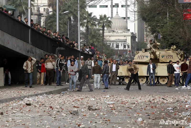Egyptian protesters are seen in and around Tahrir square, as supporters and opponents of President Hosni Mubarak clash in some parts of the square, Cairo, capital of Egypt, Feb. 3, 2011. Egyptian army appeared to be tryi...