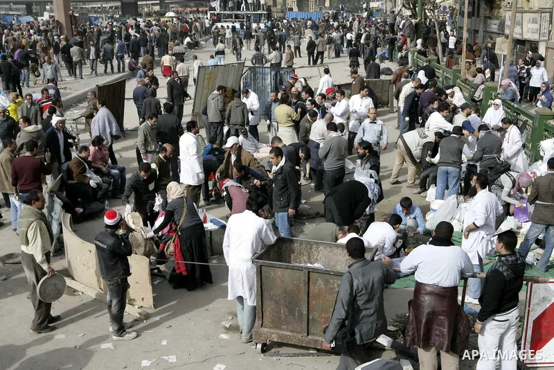 Egyptian protesters are seen in and around Tahrir square, as supporters and opponents of President Hosni Mubarak clash in some parts of the square, Cairo, capital of Egypt, Feb. 3, 2011. Egyptian army appeared to be tryi...
