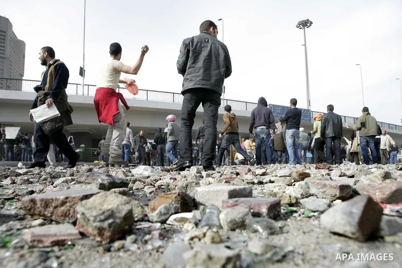 Egyptian protesters are seen in and around Tahrir square, as supporters and opponents of President Hosni Mubarak clash in some parts of the square, Cairo, capital of Egypt, Feb. 3, 2011. Egyptian army appeared to be tryi...