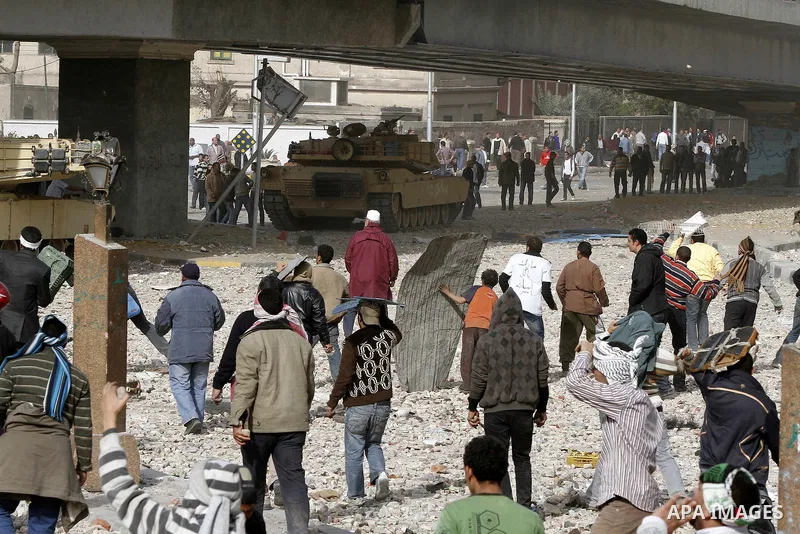 Egyptian protesters are seen in and around Tahrir square, as supporters and opponents of President Hosni Mubarak clash in some parts of the square, Cairo, capital of Egypt, Feb. 3, 2011. Egyptian army appeared to be tryi...