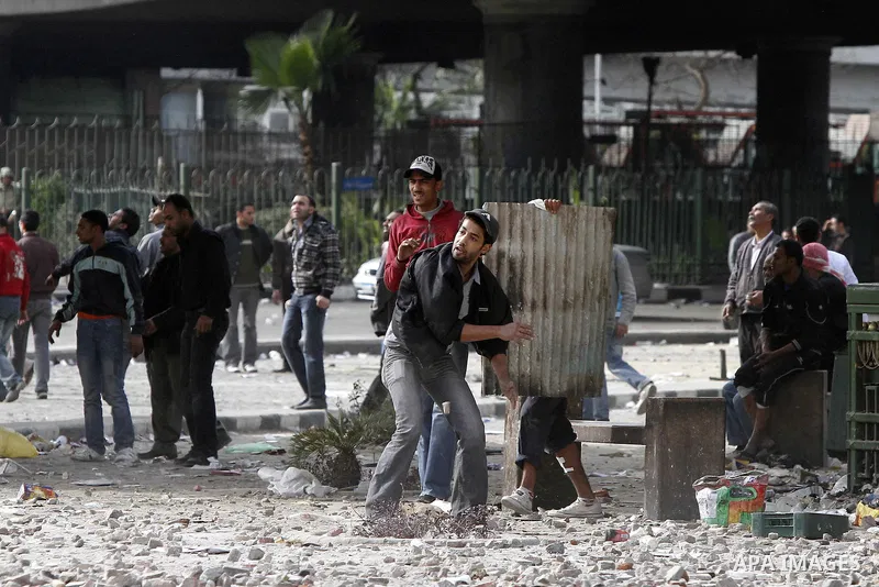 Egyptian protesters are seen in and around Tahrir square, as supporters and opponents of President Hosni Mubarak clash in some parts of the square, Cairo, capital of Egypt, Feb. 3, 2011. Egyptian army appeared to be tryi...