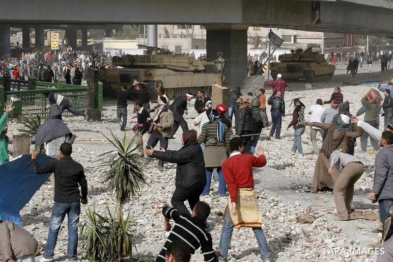Egyptian protesters are seen in and around Tahrir square, as supporters and opponents of President Hosni Mubarak clash in some parts of the square, Cairo, capital of Egypt, Feb. 3, 2011. Egyptian army appeared to be tryi...