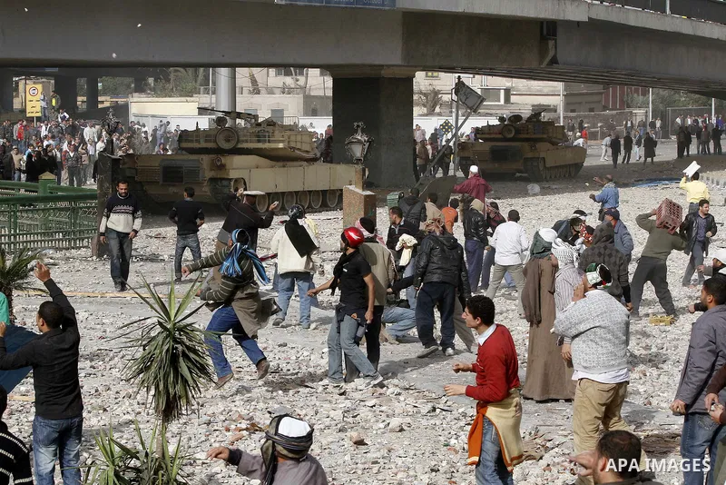 Egyptian protesters are seen in and around Tahrir square, as supporters and opponents of President Hosni Mubarak clash in some parts of the square, Cairo, capital of Egypt, Feb. 3, 2011. Egyptian army appeared to be tryi...