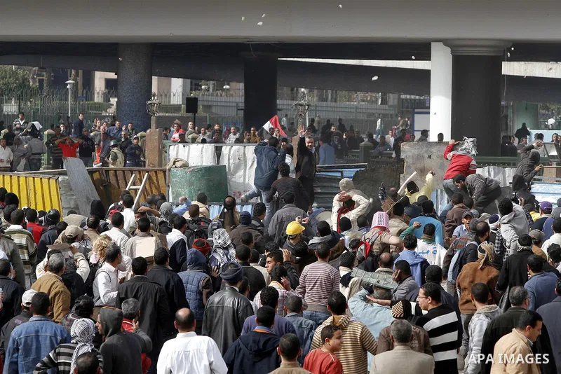 Egyptian protesters are seen in and around Tahrir square, as supporters and opponents of President Hosni Mubarak clash in some parts of the square, Cairo, capital of Egypt, Feb. 3, 2011. Egyptian army appeared to be tryi...