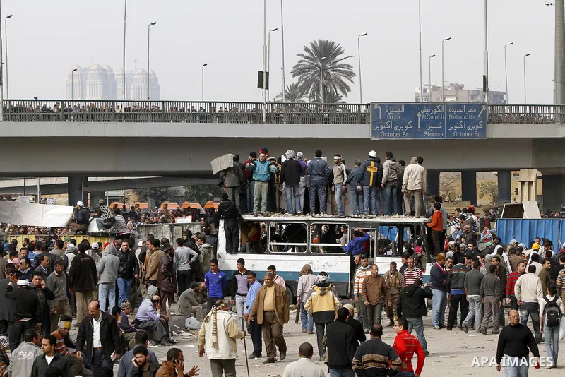 Egyptian protesters are seen in and around Tahrir square, as supporters and opponents of President Hosni Mubarak clash in some parts of the square, Cairo, capital of Egypt, Feb. 3, 2011. Egyptian army appeared to be tryi...