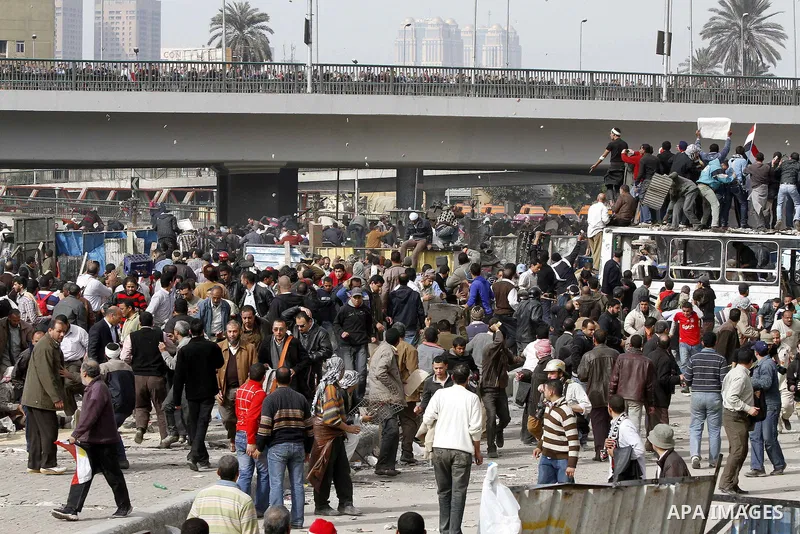 Egyptian protesters are seen in and around Tahrir square, as supporters and opponents of President Hosni Mubarak clash in some parts of the square, Cairo, capital of Egypt, Feb. 3, 2011. Egyptian army appeared to be tryi...