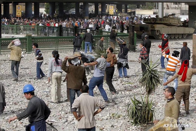 Egyptian protesters are seen in and around Tahrir square, as supporters and opponents of President Hosni Mubarak clash in some parts of the square, Cairo, capital of Egypt, Feb. 3, 2011. Egyptian army appeared to be tryi...