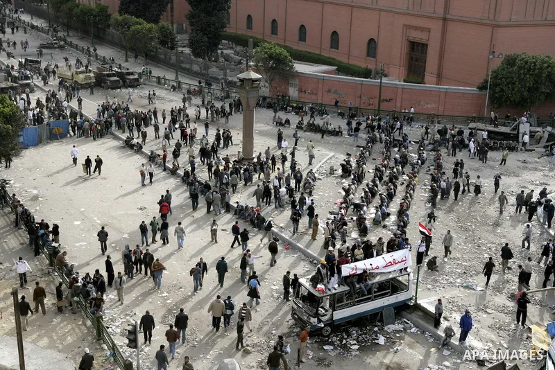 Egyptian protesters are seen in and around Tahrir square, as supporters and opponents of President Hosni Mubarak clash in some parts of the square, Cairo, capital of Egypt, Feb. 3, 2011. Egyptian army appeared to be tryi...