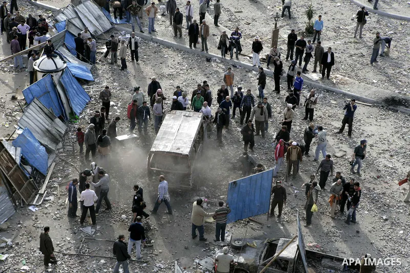 Egyptian protesters are seen in and around Tahrir square, as supporters and opponents of President Hosni Mubarak clash in some parts of the square, Cairo, capital of Egypt, Feb. 3, 2011. Egyptian army appeared to be tryi...