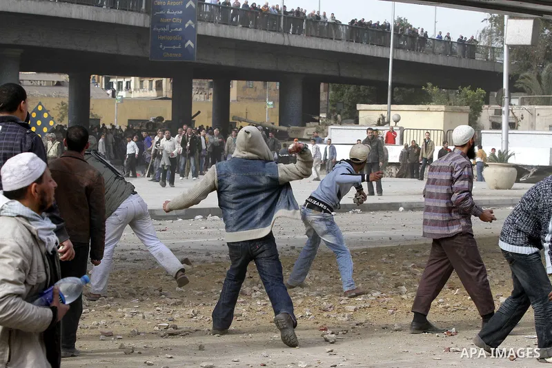 Egyptian protesters are seen in and around Tahrir square, as supporters and opponents of President Hosni Mubarak clash in some parts of the square, Cairo, capital of Egypt, Feb. 3, 2011. Egyptian army appeared to be tryi...